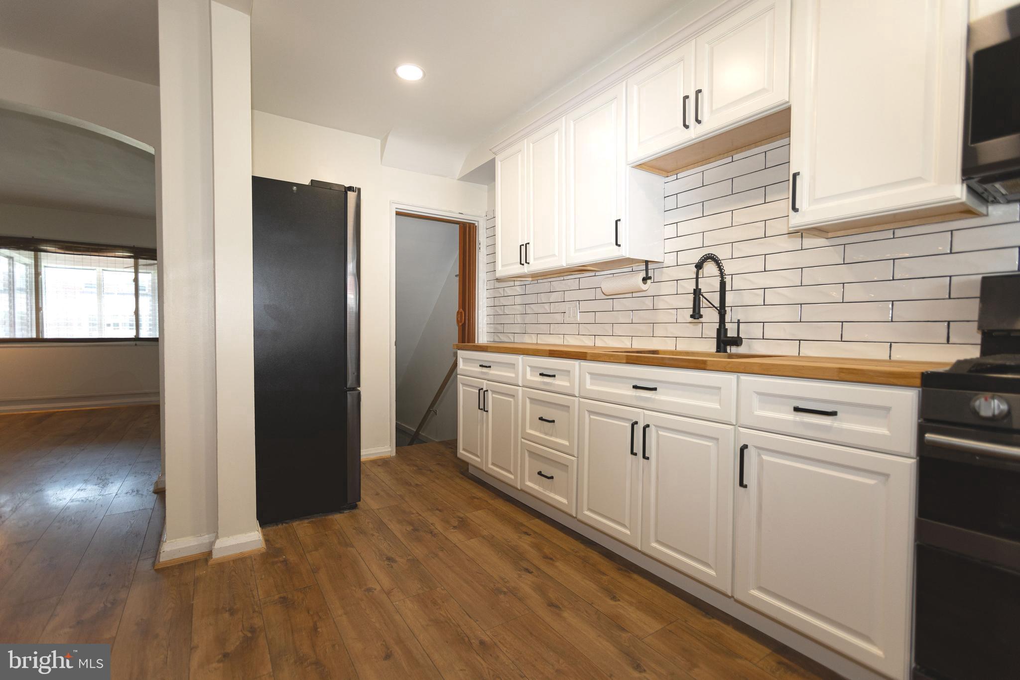 1940 Wareham Road Baltimore, MD 21222 - Photo 12 of 37 a kitchen with stainless steel appliances granite countertop a refrigerator a sink and white cabinets