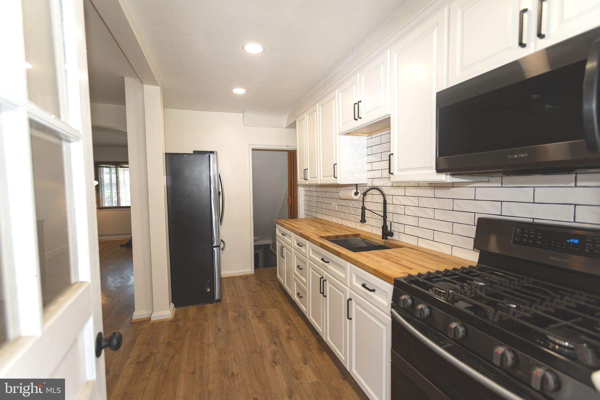 1940 Wareham Road Baltimore, MD 21222 - Photo 13 of 37 a kitchen with stainless steel appliances granite countertop a sink stove and refrigerator