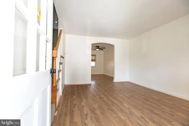 a view of an entryway with wooden floor and stairs