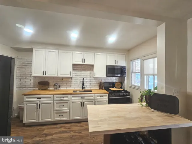 a outdoor living room with furniture and a potted plant