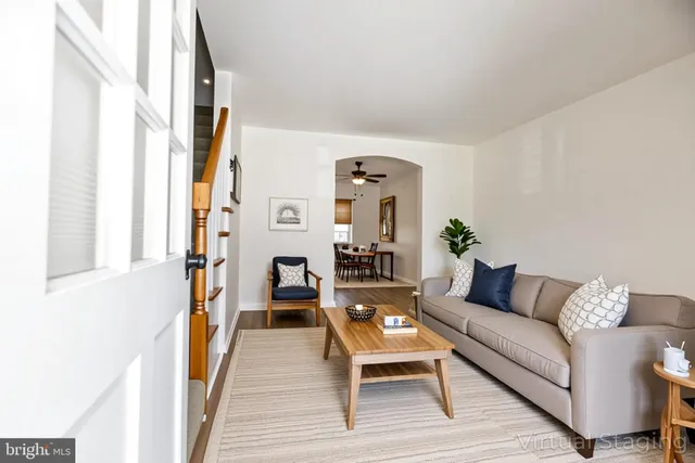 a living room with furniture and a potted plant