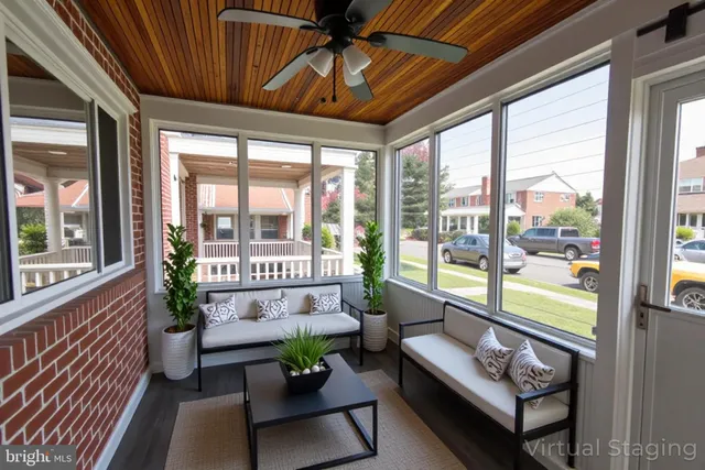a kitchen with stainless steel appliances kitchen island granite countertop a dining table chairs and a refrigerator