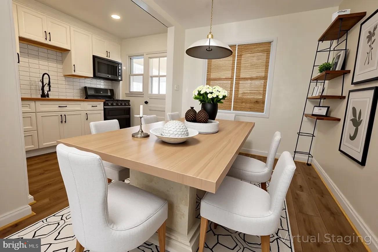 1940 Wareham Road Baltimore, MD 21222 - Photo 6 of 37 a kitchen with stainless steel appliances kitchen island granite countertop a dining table chairs and a refrigerator