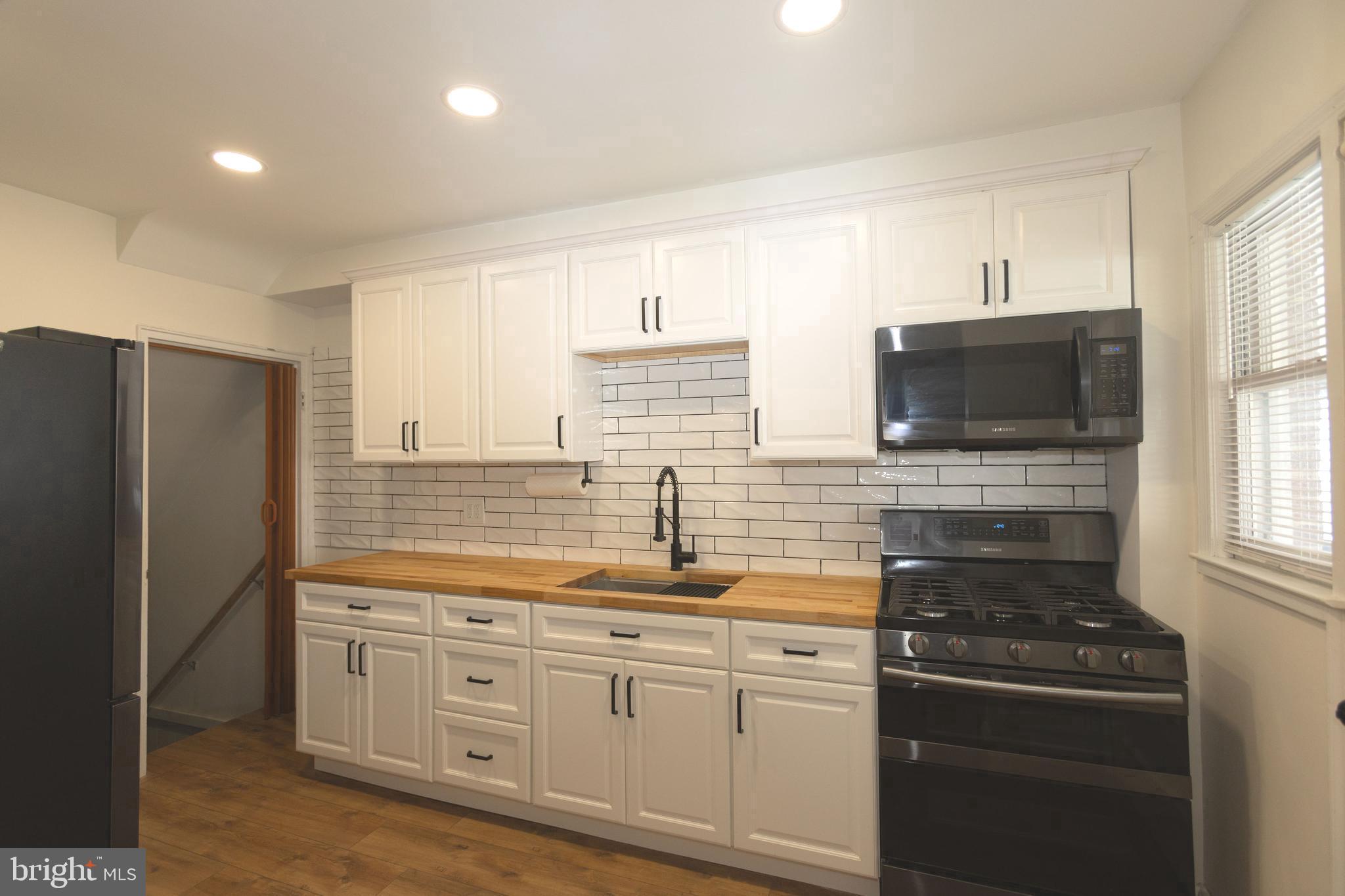 1940 Wareham Road Baltimore, MD 21222 - Photo 7 of 37 a kitchen with stainless steel appliances granite countertop a stove a sink and a refrigerator