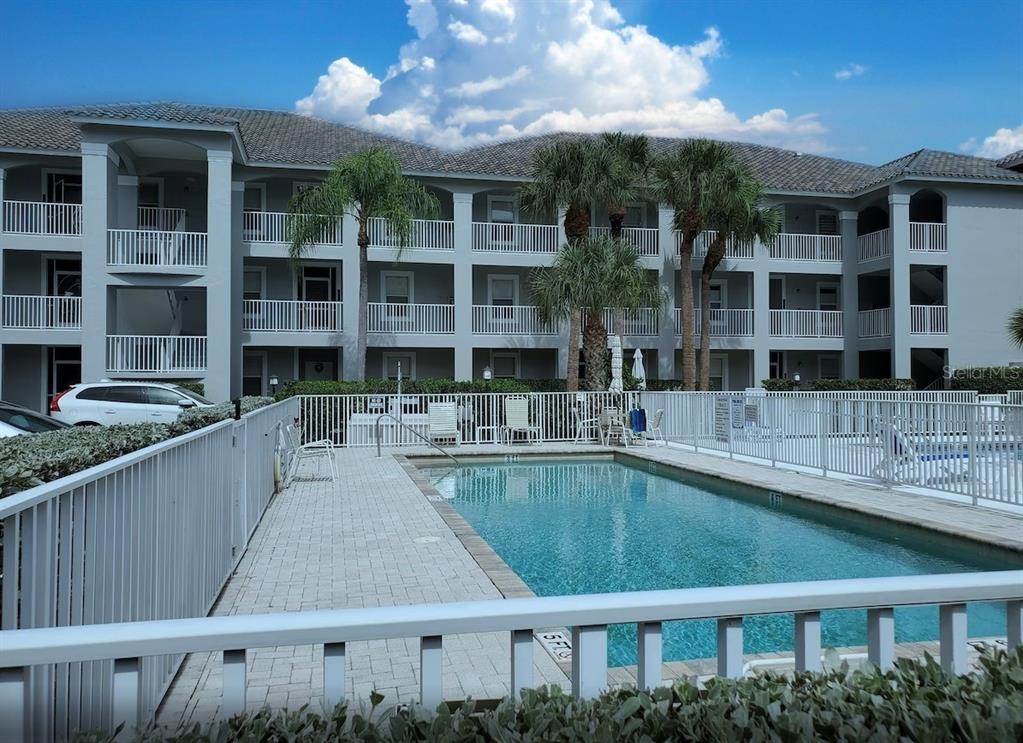 519 Roma Court, Unit 3307 Naples, FL 34110 - Photo 1 of 1 a swimming pool view with a outdoor seating