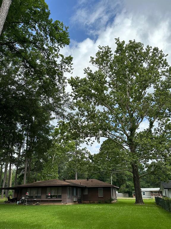 6371 Buncombe Road Shreveport, LA 71129 - Photo 9 of 17 a view of a green field with wooden fence