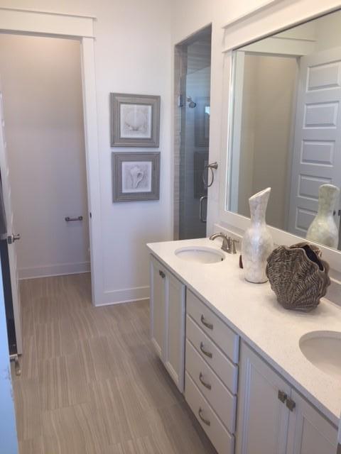 100 Pine Lands Loop Inlet Beach, Unit 463C Inlet Beach, FL 32461 - Photo 8 of 12 a bathroom with a double vanity sink and a mirror