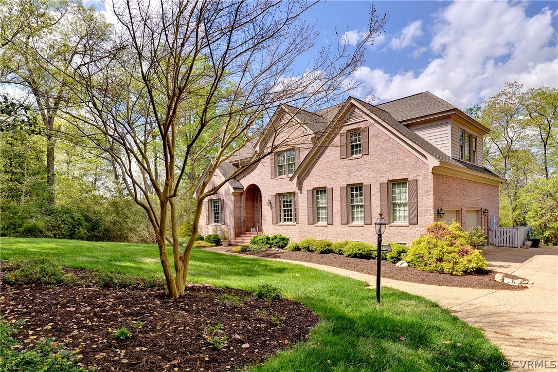 207 Shady Bluff Point Williamsburg, VA 23188 - Photo 2 of 49 a front view of a house with a garden