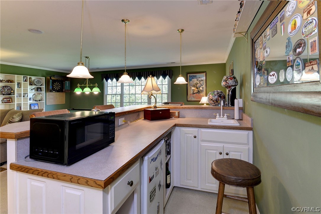 207 Shady Bluff Point Williamsburg, VA 23188 - Photo 25 of 49 a kitchen with a sink and a stove with wooden floor