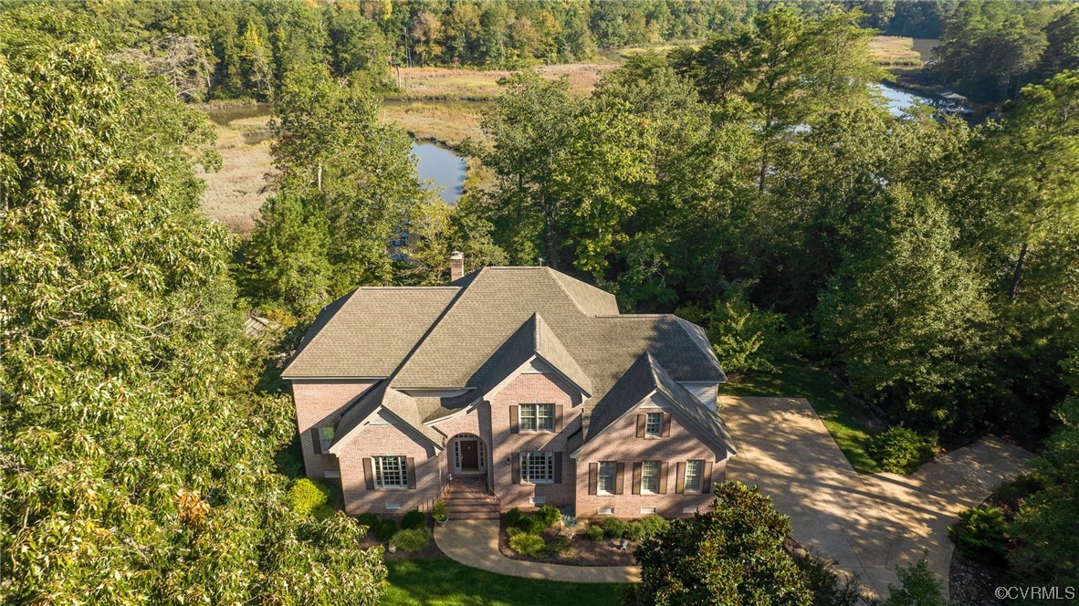 207 Shady Bluff Point Williamsburg, VA 23188 - Photo 33 of 49 an aerial view of a house with garden space and trees in the background