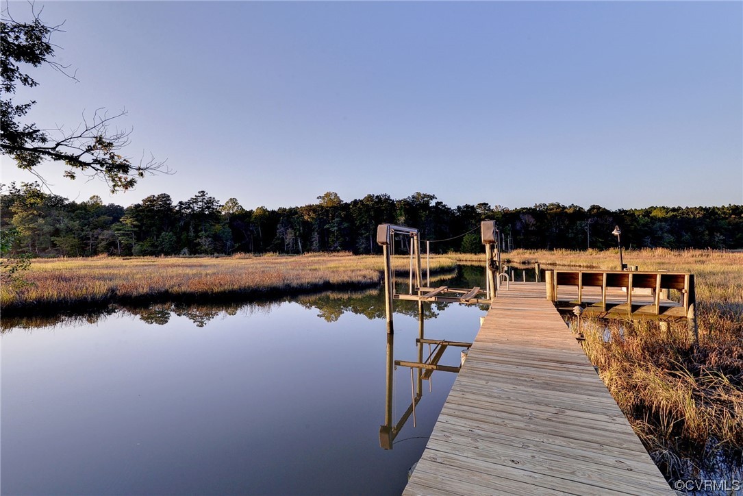 207 Shady Bluff Point Williamsburg, VA 23188 - Photo 39 of 49 a view of wooden deck and lake with trees in the background