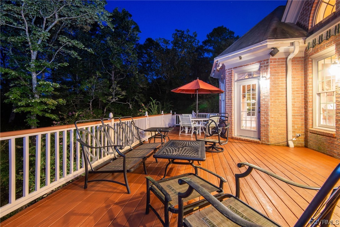 207 Shady Bluff Point Williamsburg, VA 23188 - Photo 47 of 49 a view of a patio with a table and chairs under an umbrella with a small barbeque