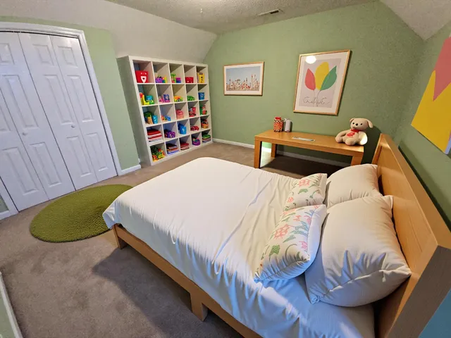 a bedroom with a bed and a window