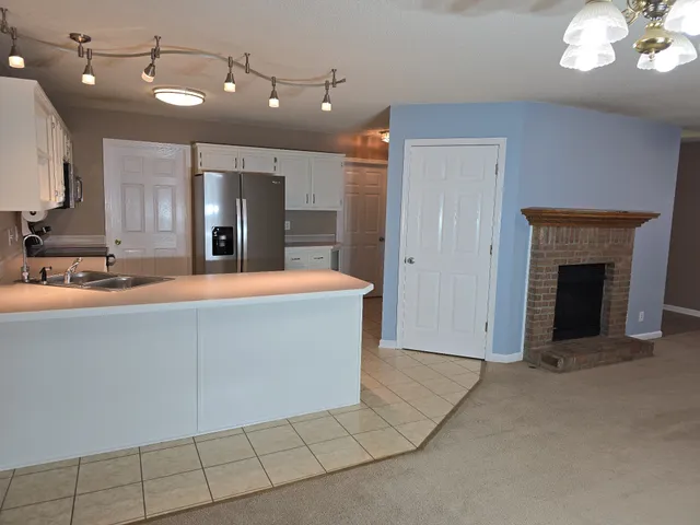 a view of a kitchen with a sink and a fireplace