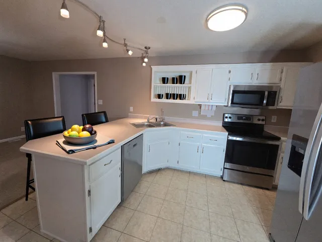 a kitchen with a sink stove and microwave