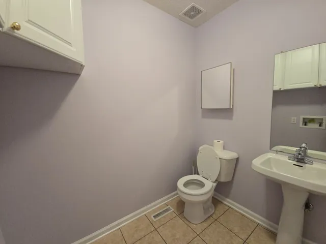 a white toilet sitting next to a bathroom sink