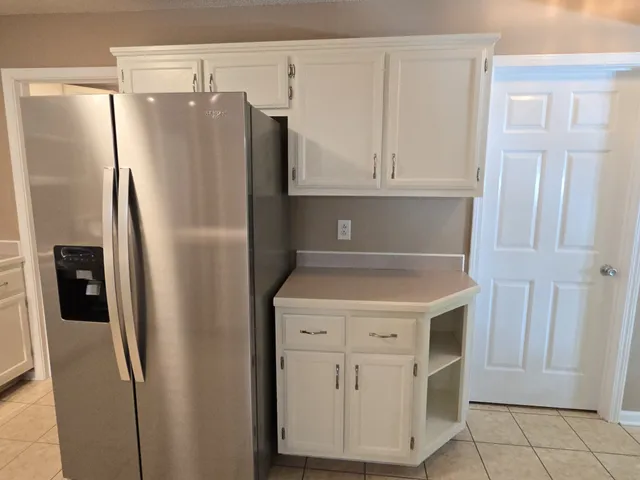 a kitchen with metallic refrigerator freezer and a dishwasher