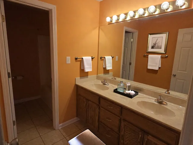a bathroom with a double vanity sink and a mirror