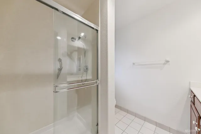 a bathroom with a glass shower door
