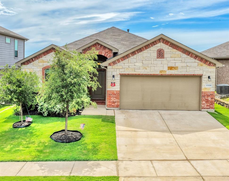 Beautiful curb appeal with lush landscaping & trees