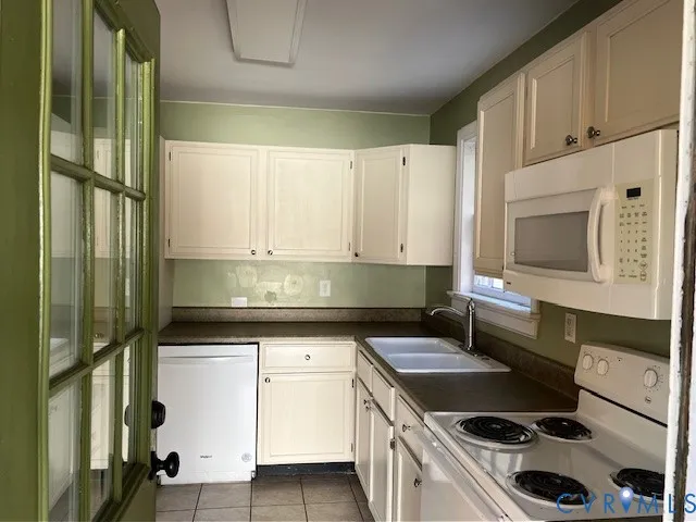 a kitchen with a sink cabinets and stainless steel appliances