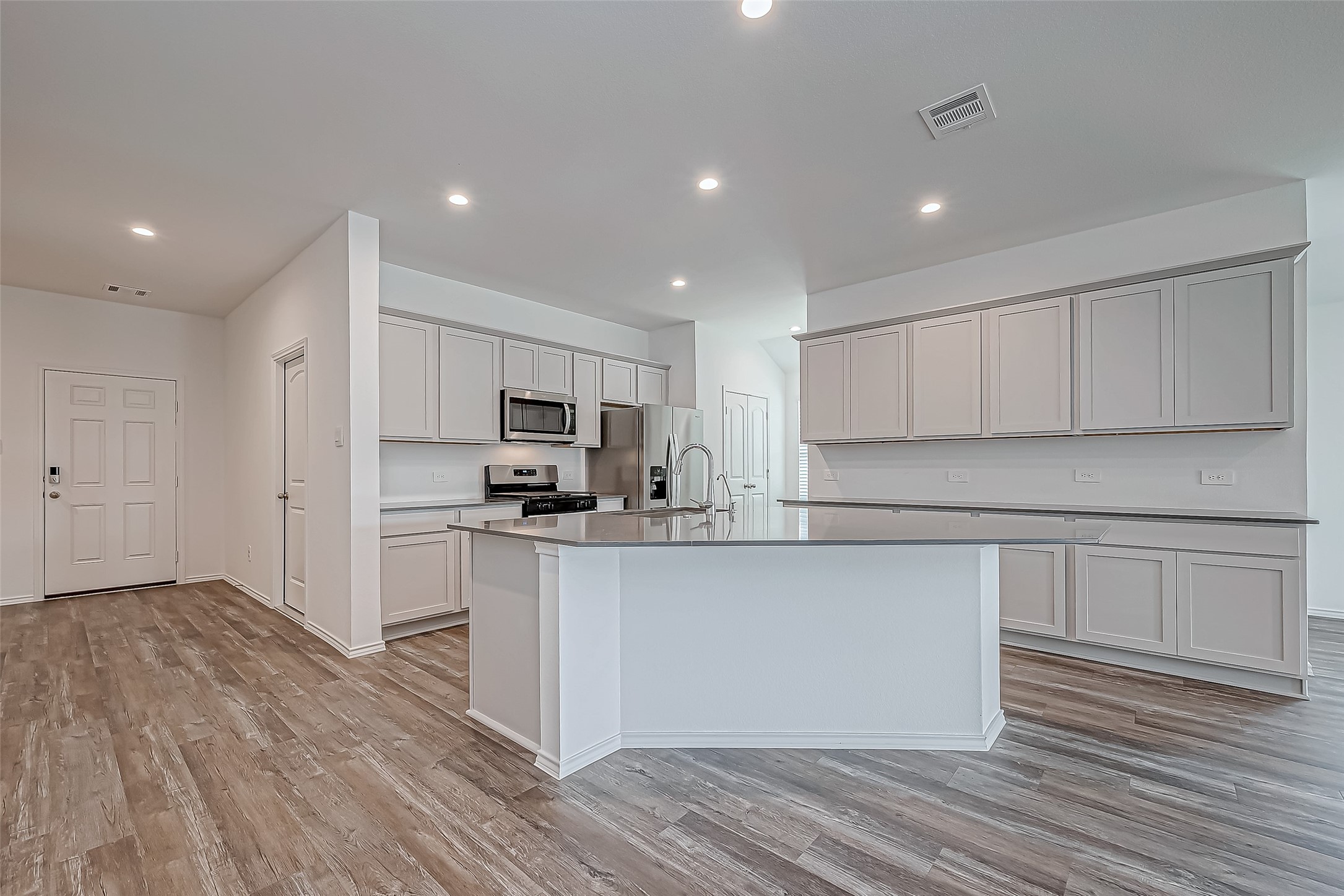 532 Comal Trail Dayton, TX 77535 - Photo 11 of 26 a kitchen with stainless steel appliances refrigerator sink and cabinets