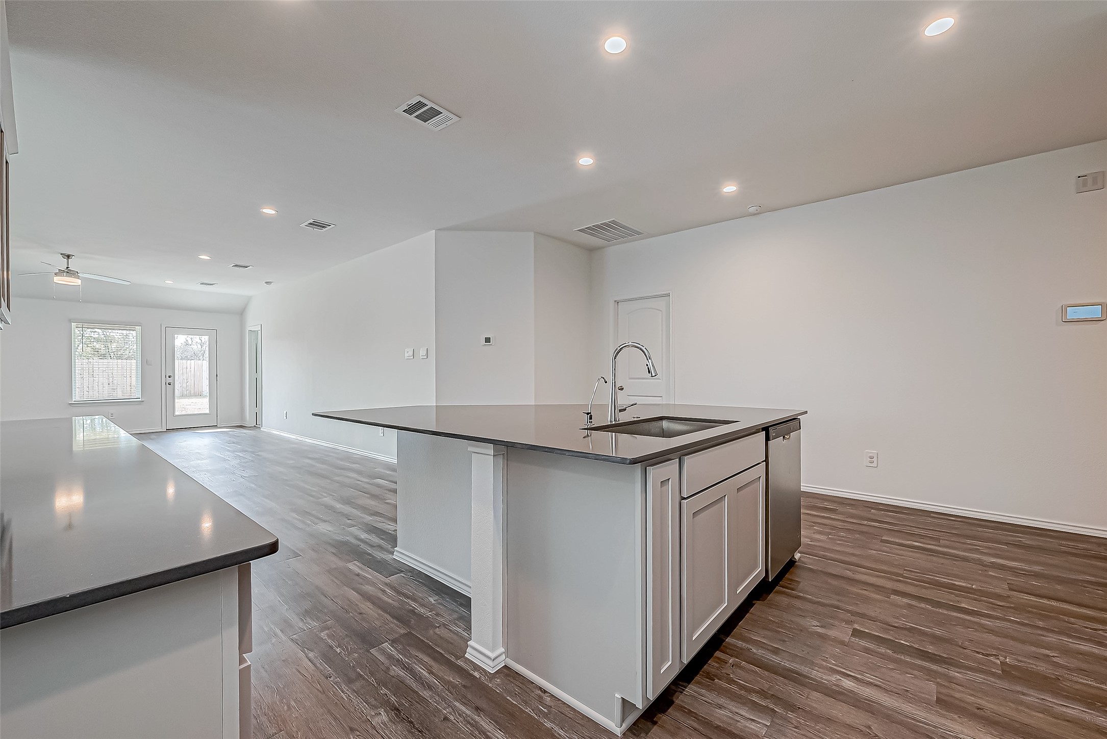 532 Comal Trail Dayton, TX 77535 - Photo 8 of 26 a kitchen with stainless steel appliances granite countertop a sink stove and wooden floor