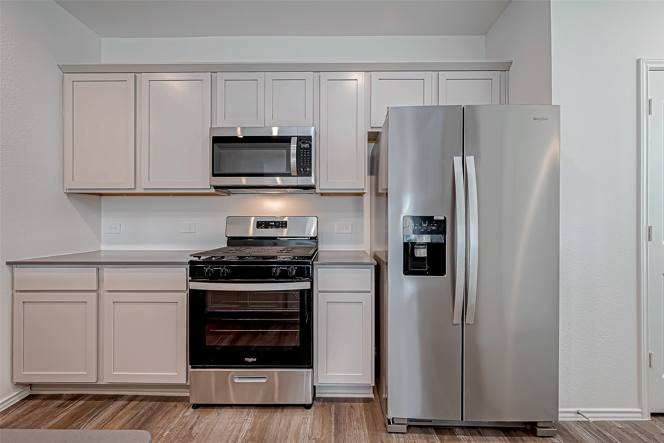 532 Comal Trail Dayton, TX 77535 - Photo 9 of 26 a kitchen with stainless steel appliances a refrigerator stove and microwave