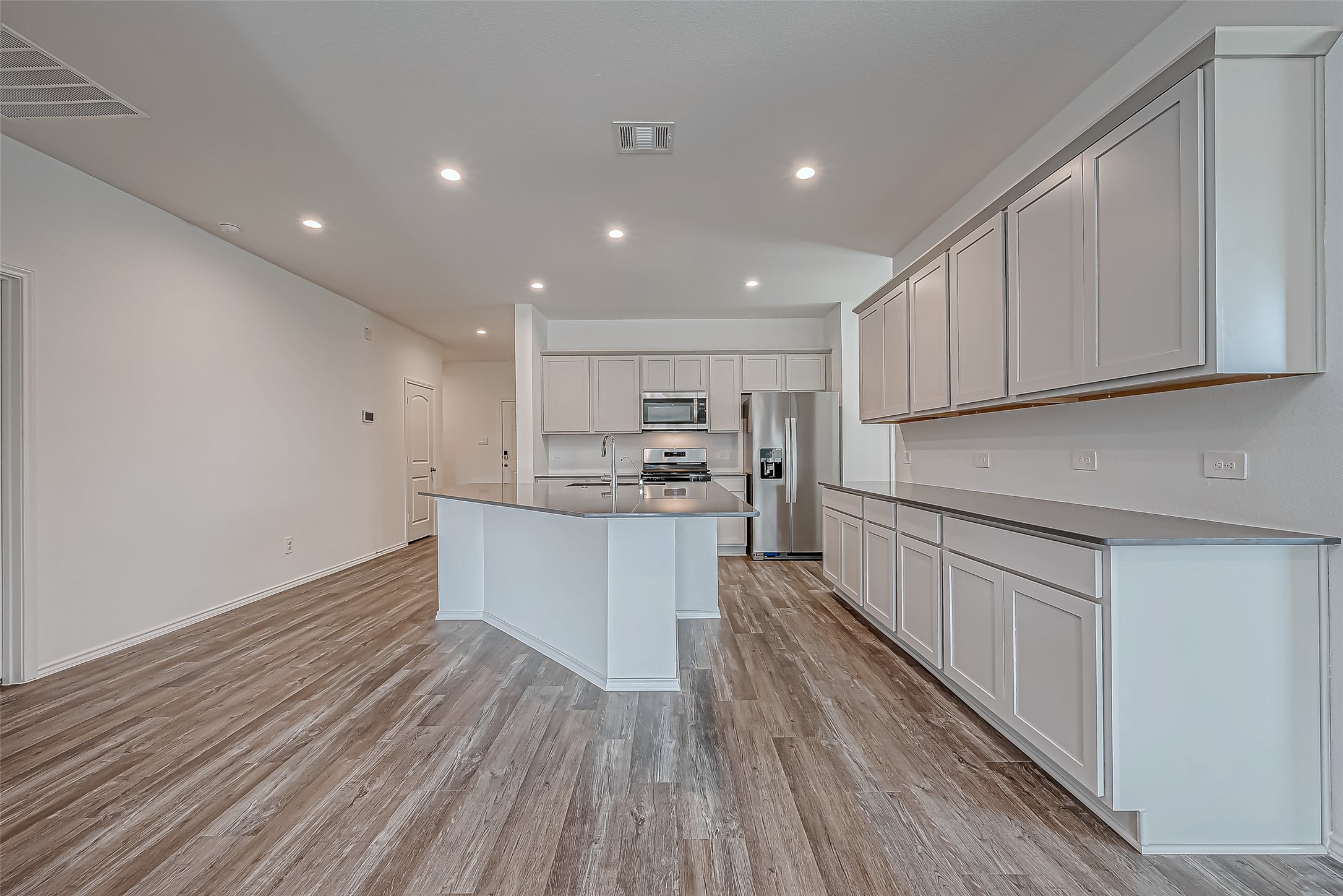 532 Comal Trail Dayton, TX 77535 - Photo 10 of 26 a kitchen with a sink wooden floor and stainless steel appliances