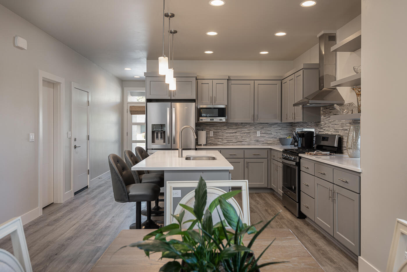 62011 Dantili Road Bend, OR 97701 - Photo 8 of 25 a kitchen with stainless steel appliances kitchen island granite countertop a sink a stove a refrigerator and a microwave