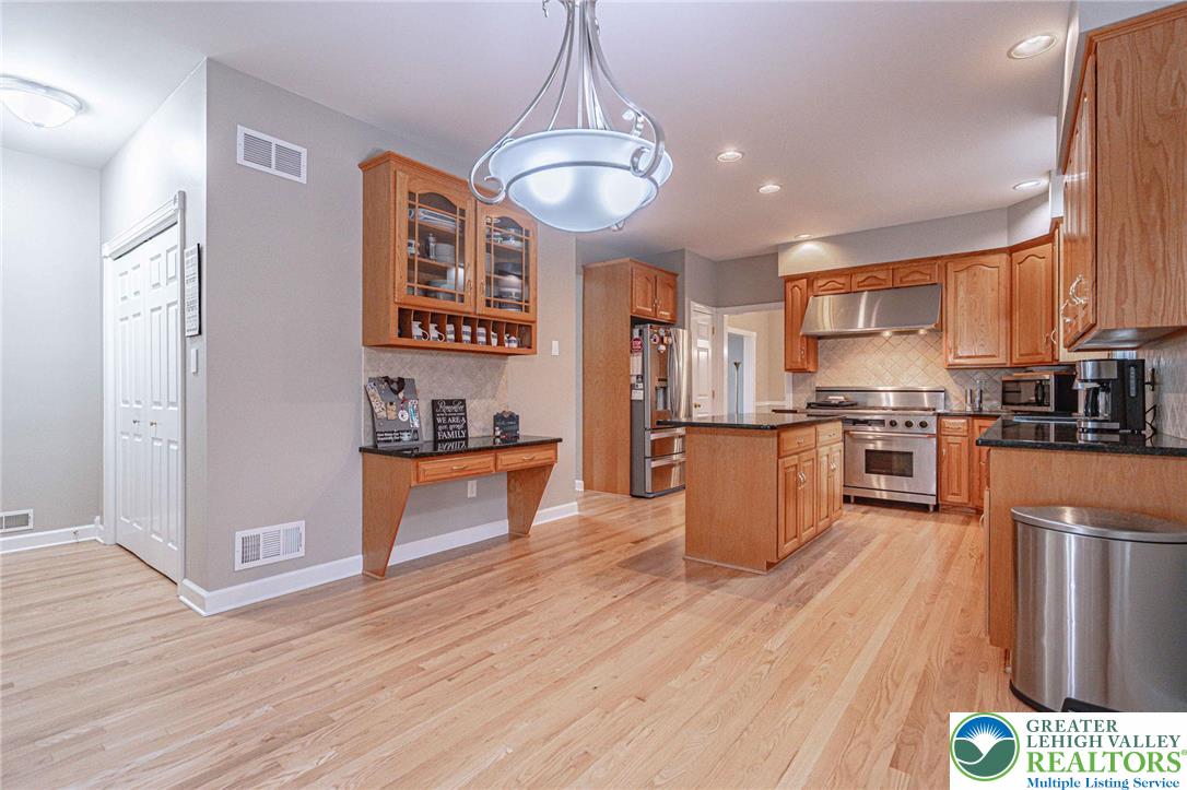 6551 Overlook Road Orefield, PA 18069 - Photo 29 of 82 a kitchen with stainless steel appliances granite countertop a stove a sink and a refrigerator