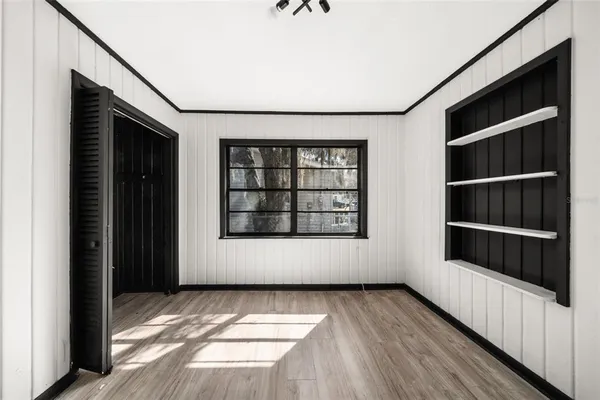a view of walk in closet with wooden floor