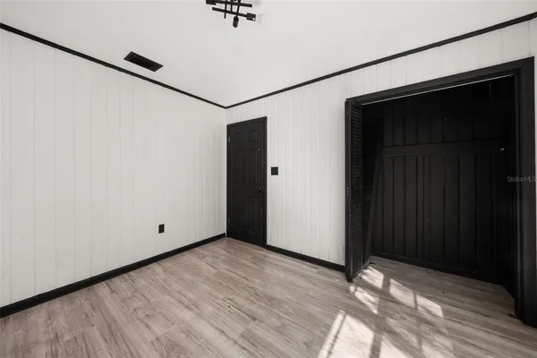 a view of a room with wooden floor