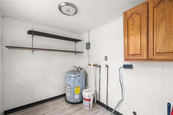 a view of a closet area with wooden floor
