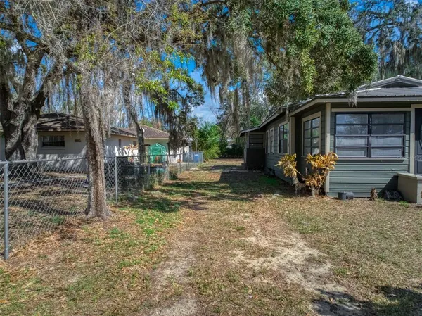 a view of backyard of house with seating space