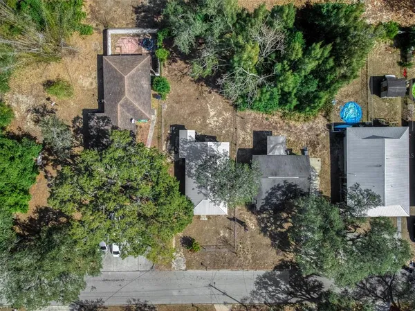 an aerial view of a house with a yard