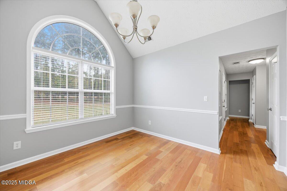 2764 Dames Ferry Road Forsyth, GA 31029 - Photo 12 of 30 a view of empty room with wooden floor and fan