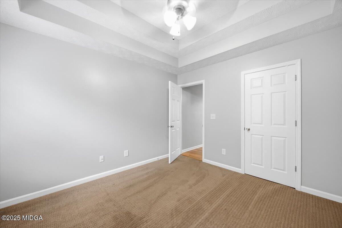 2764 Dames Ferry Road Forsyth, GA 31029 - Photo 17 of 30 an empty room with a chandelier fan and closet area