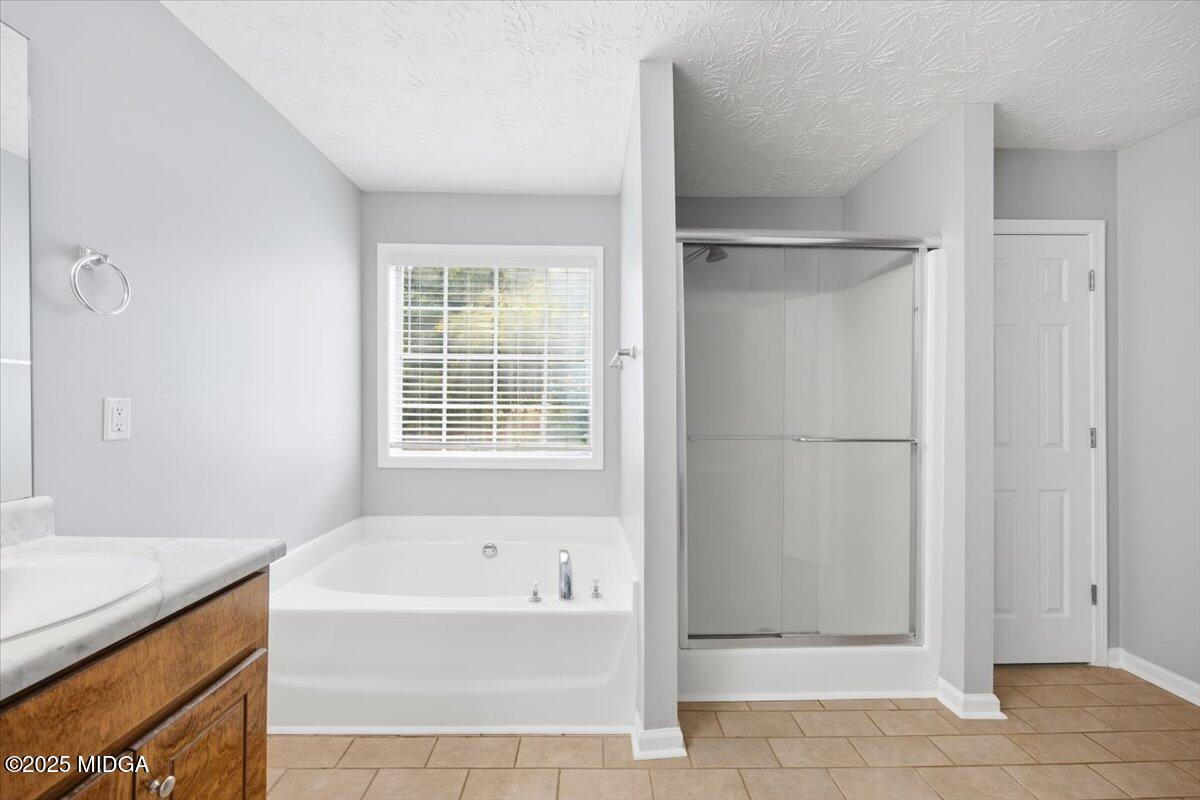 2764 Dames Ferry Road Forsyth, GA 31029 - Photo 21 of 30 a bathroom with a bathtub and a shower