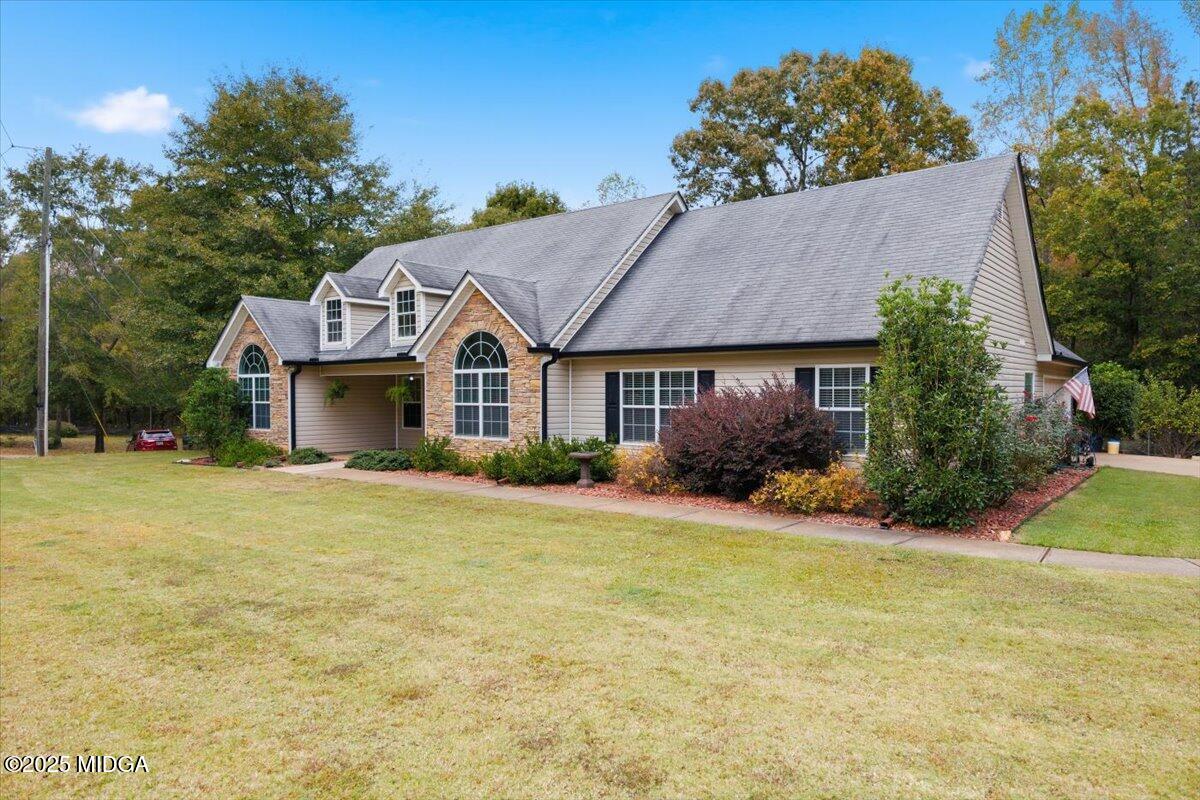 2764 Dames Ferry Road Forsyth, GA 31029 - Photo 24 of 30 a front view of a house with a yard and garage