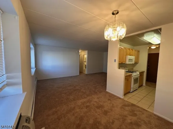 a view of a livingroom with a kitchen