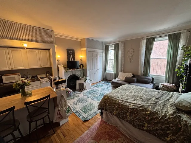 a bedroom with a bed window and couch