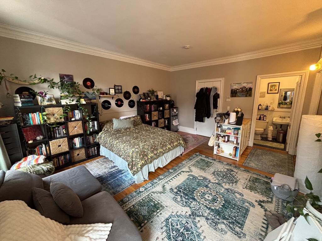 98 Charles Street, Unit 9 Boston, MA 02114 - Photo 3 of 7 a living room with furniture and a flat screen tv