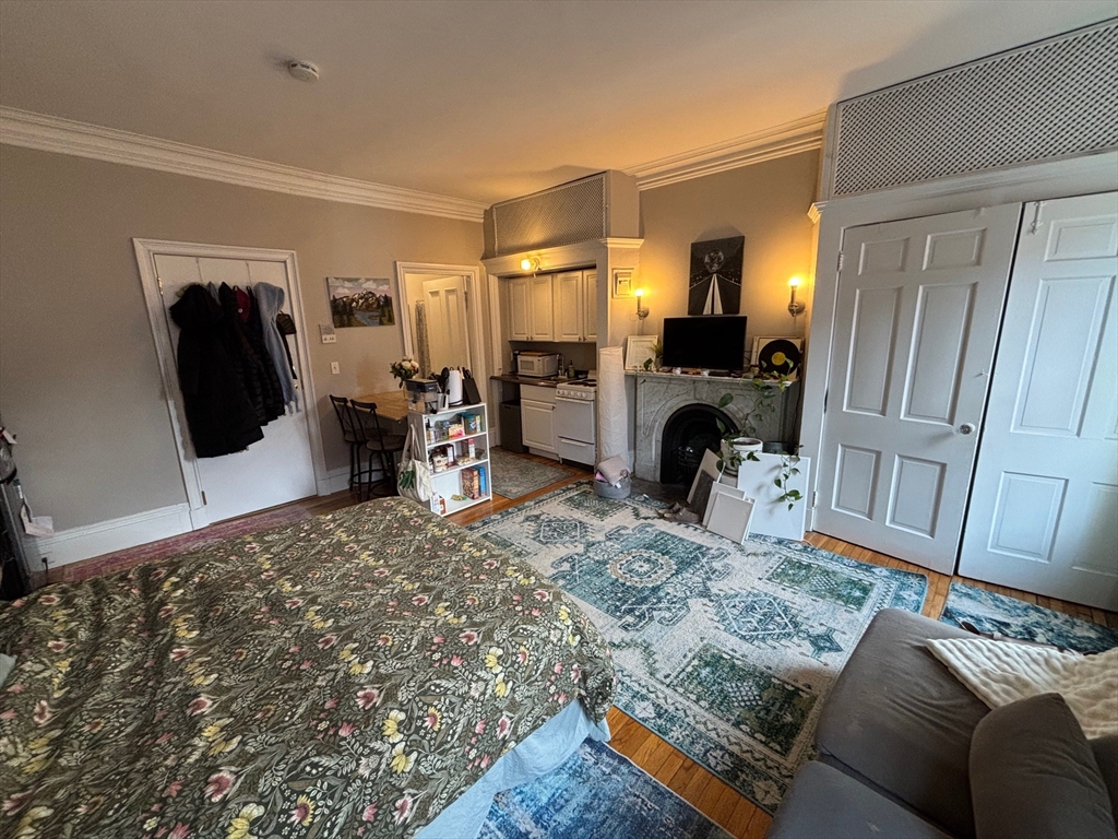98 Charles Street, Unit 9 Boston, MA 02114 - Photo 4 of 7 a living room with furniture and a fireplace