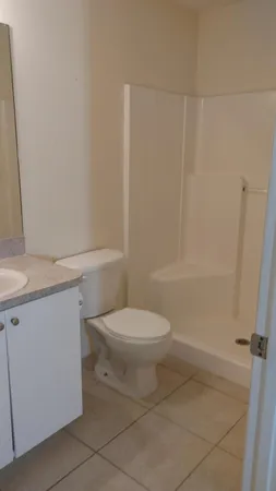 a bathroom with a toilet a sink and shower