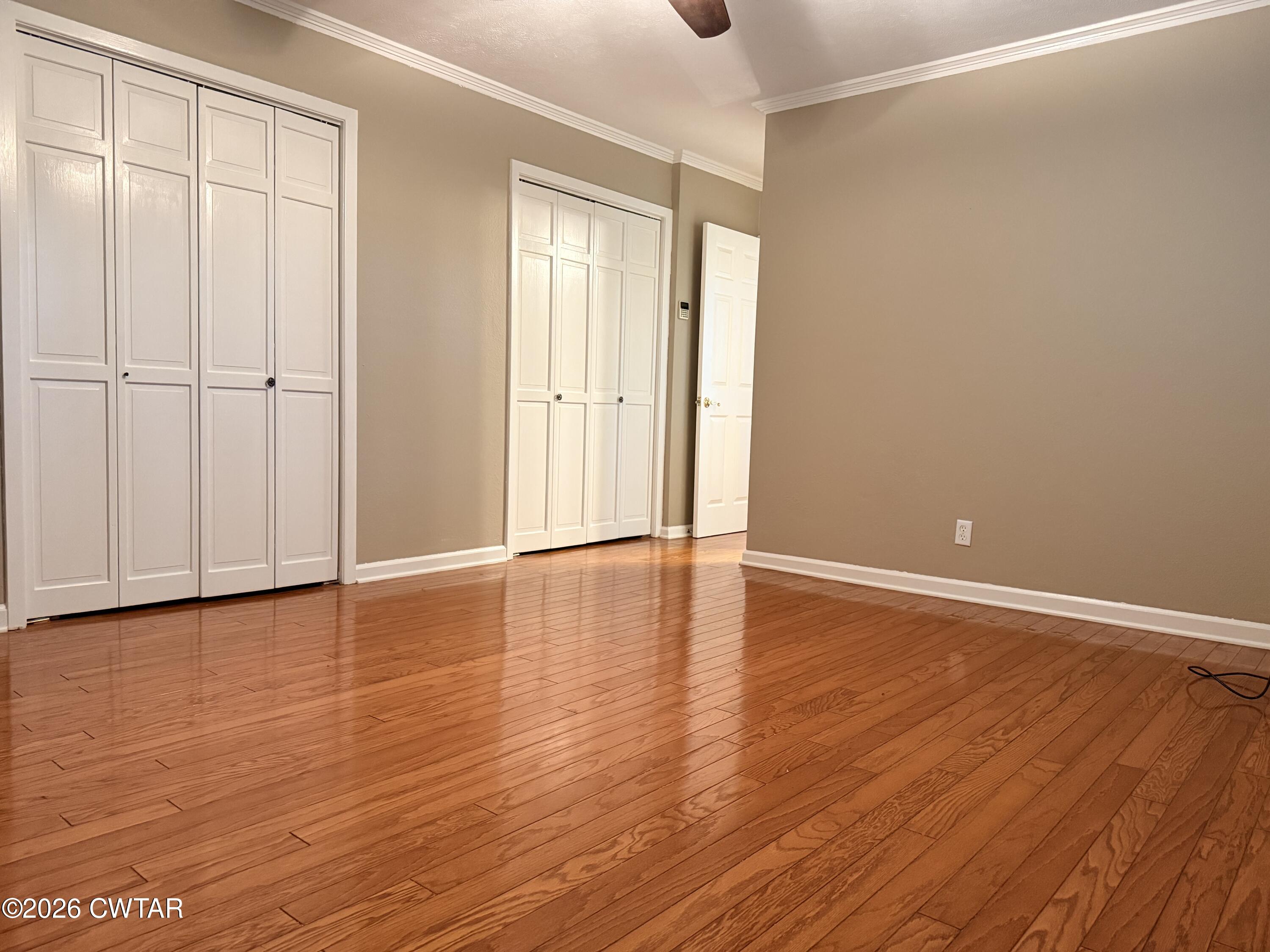 261 Lackey Lane Ripley, TN 38063 - Photo 28 of 48 a view of an empty room with wooden floor and a window
