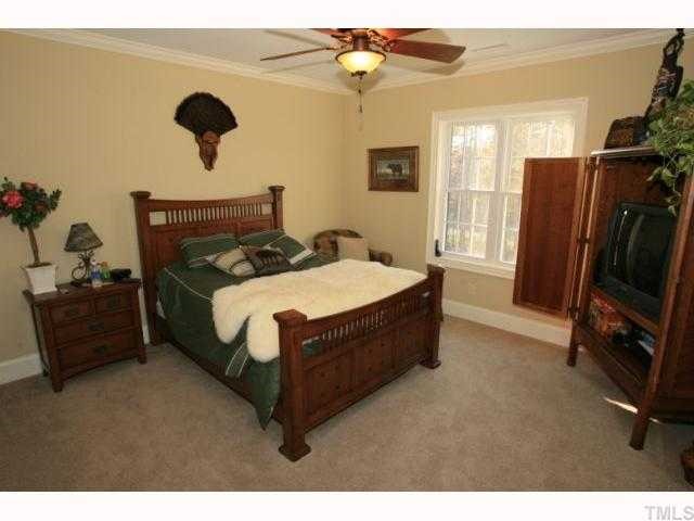 9004 Albatross Court Raleigh, NC 27613 - Photo 11 of 12 a bedroom with a bed dresser and a window