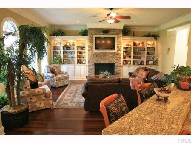 9004 Albatross Court Raleigh, NC 27613 - Photo 2 of 12 a living room with furniture fireplace and flat screen tv