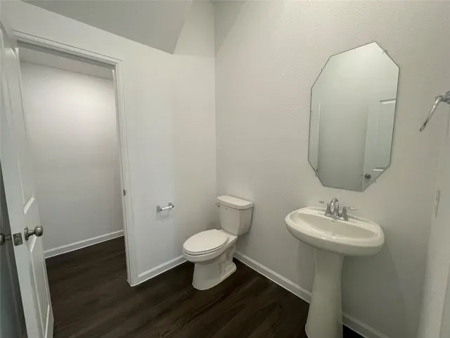 a bathroom with a sink toilet and a mirror