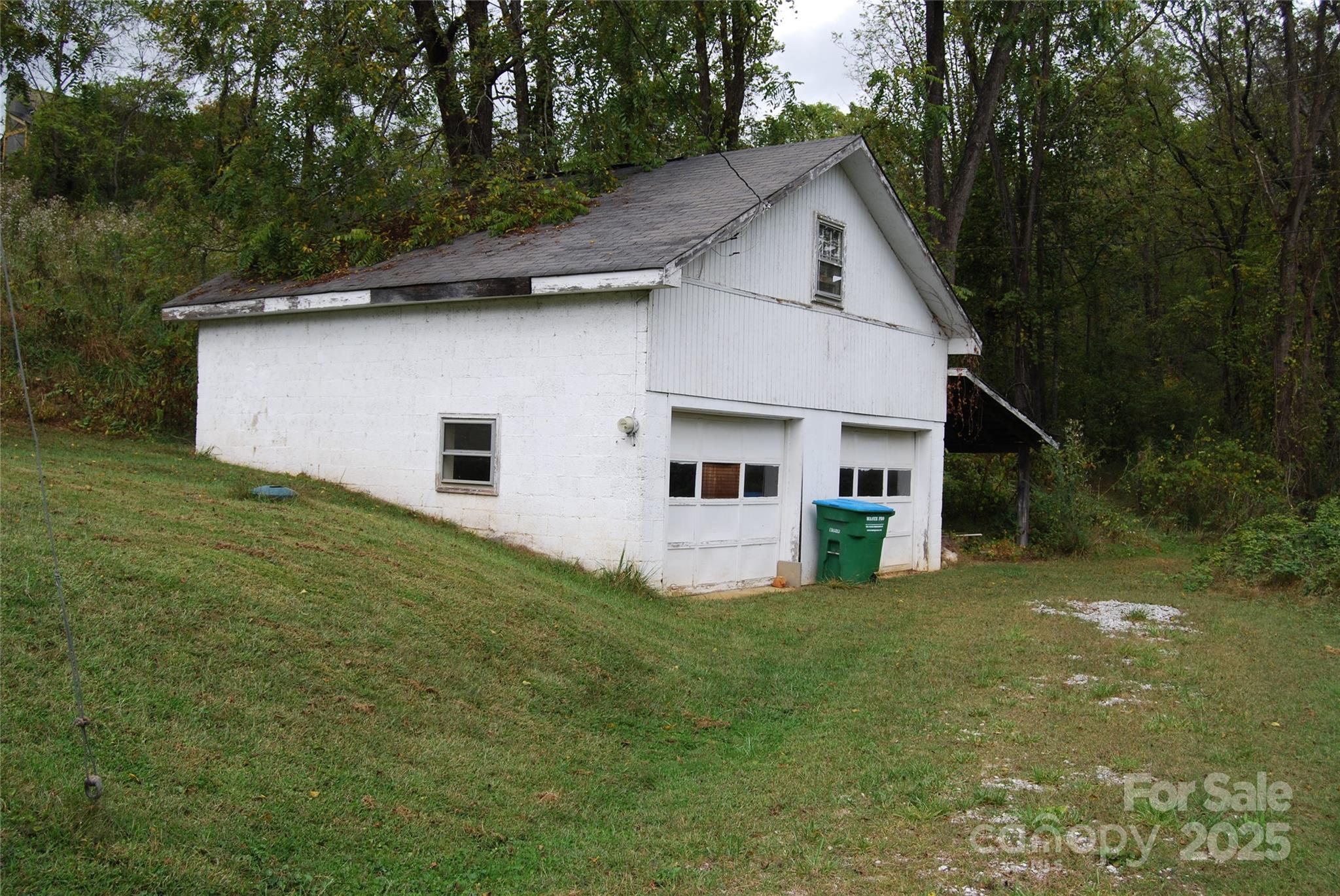 7 Noble Road Fairview, NC 28730 - Photo 14 of 44 a front view of house with yard and trees in the background
